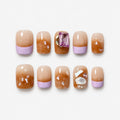 catalog: Short square press-on nails in warm amber with lilac French tips, shell flecks and a pink rectangular gem.