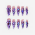 catalog: Long stiletto press-on nails in translucent purple with sculpted glass-like shards flashing blue and violet.