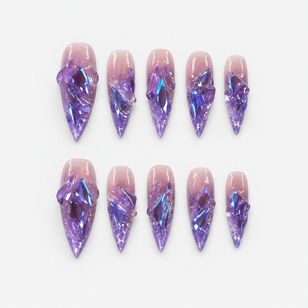 catalog: Long stiletto press-on nails in translucent purple with sculpted glass-like shards flashing blue and violet.