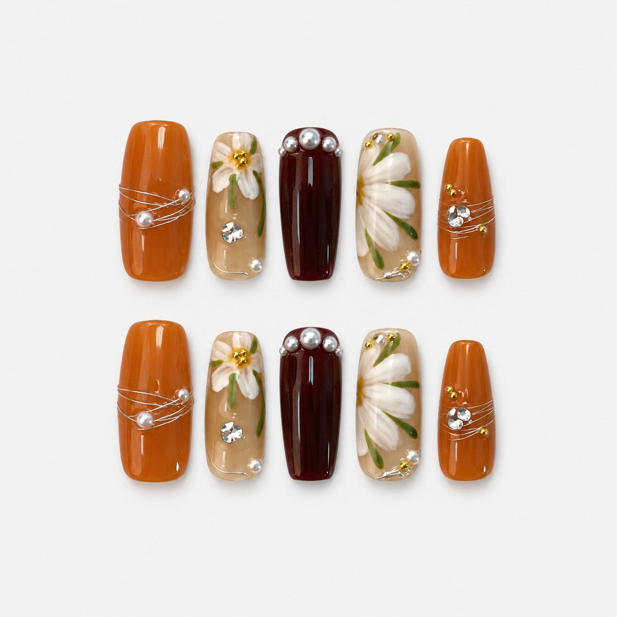catalog: Long coffin press-on nails in amber, dark wine and sheer honey, with hand-painted white daisies, gold wire wrapping, pearls and crystals.