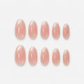 catalog: Short almond nails in sheer pink nude with glossy finish and shimmering pale champagne French tips.