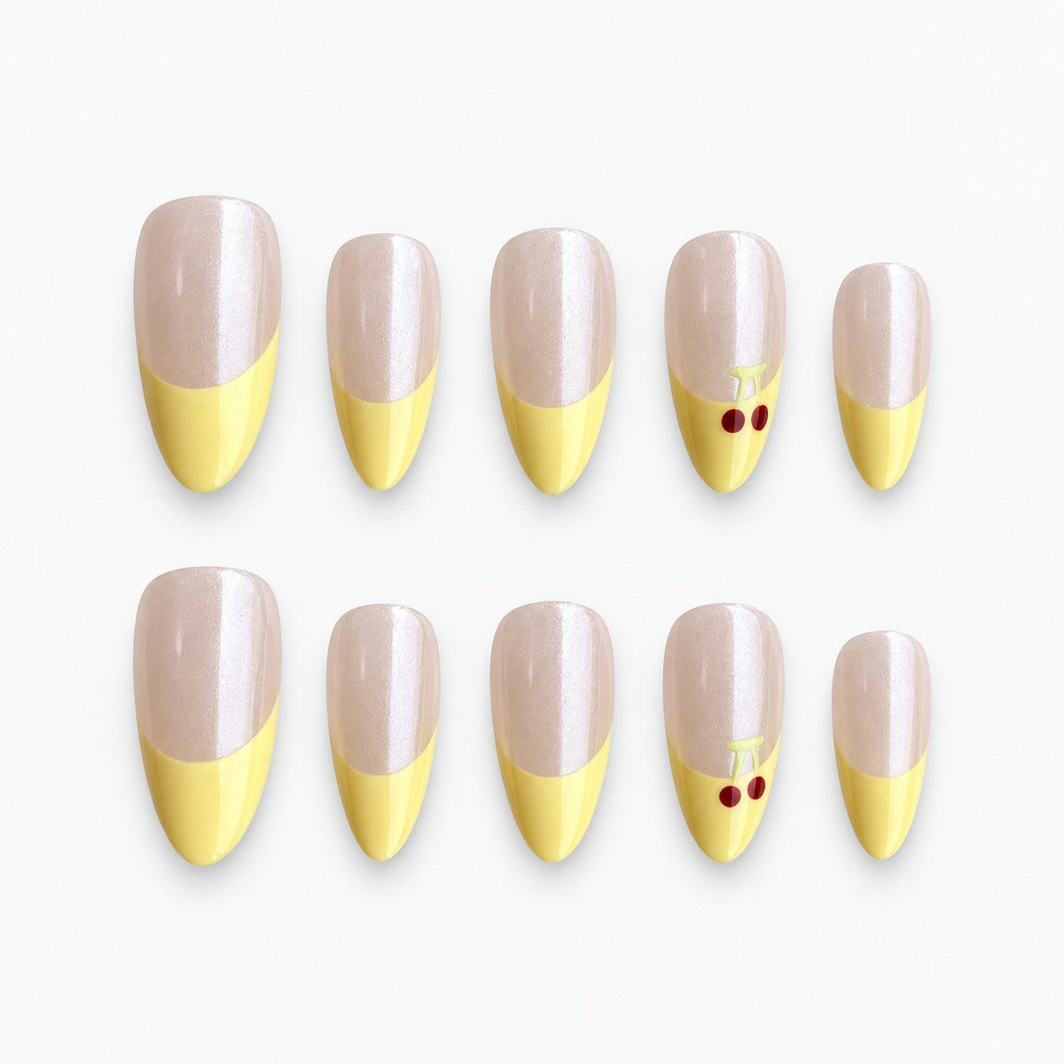 catalog: Medium almond press-on nails with a pearly nude base, pastel yellow French tips and small red painted cherries on one accent nail.