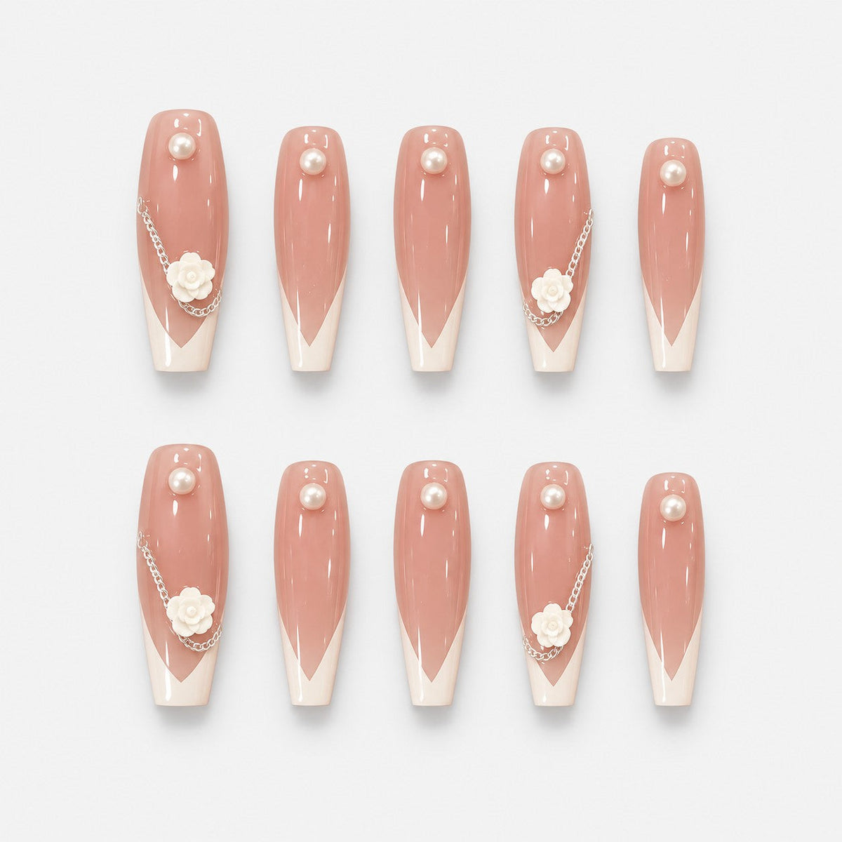 catalog: Long almond press-on nails with sheer blush base, soft white French tips, a sculpted white camellia flower, a silver chain and single pearls.