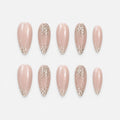 catalog: Long almond press-on set in sheer nude with pearly shimmer and champagne gold glitter tips.
