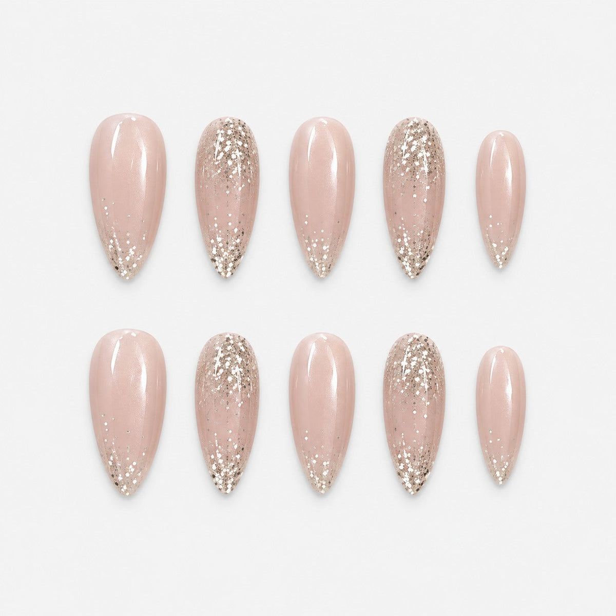 catalog: Long almond press-on set in sheer nude with pearly shimmer and champagne gold glitter tips.
