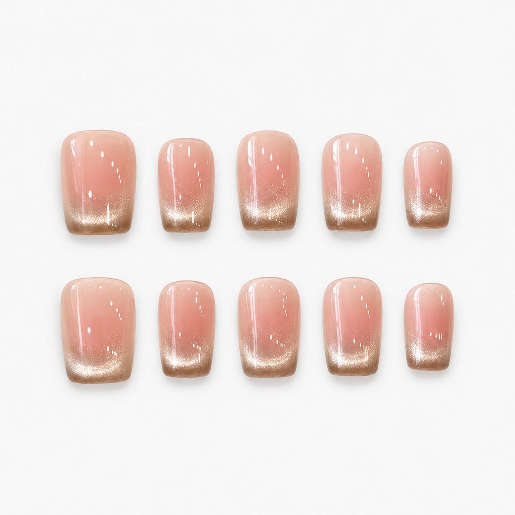 catalog: Short square press-on nails with a blush pink base fading into a shimmering champagne gold gradient tip.