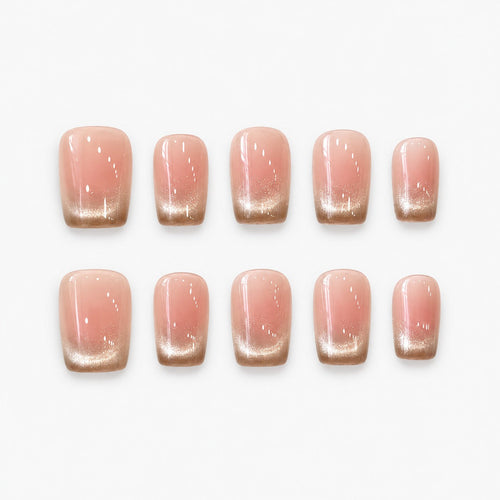 catalog: Short square press-on nails with a blush pink base fading into a shimmering champagne gold gradient tip.