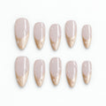 catalog: Medium almond press-on nails with a milky blush base, shimmering champagne French tips and small scattered pearls.
