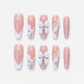 catalog: Long nude coffin nails with white French tips, a large white sculpted bow and rows of small pearls.