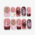 catalog: Medium square press-on nails in rose and wine gradient with white French tips, sculpted flowers, gold shell charms and glossy droplets.