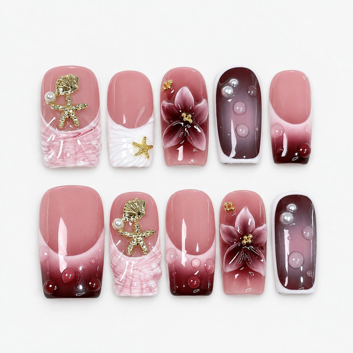 catalog: Medium square press-on nails in rose and wine gradient with white French tips, sculpted flowers, gold shell charms and glossy droplets.