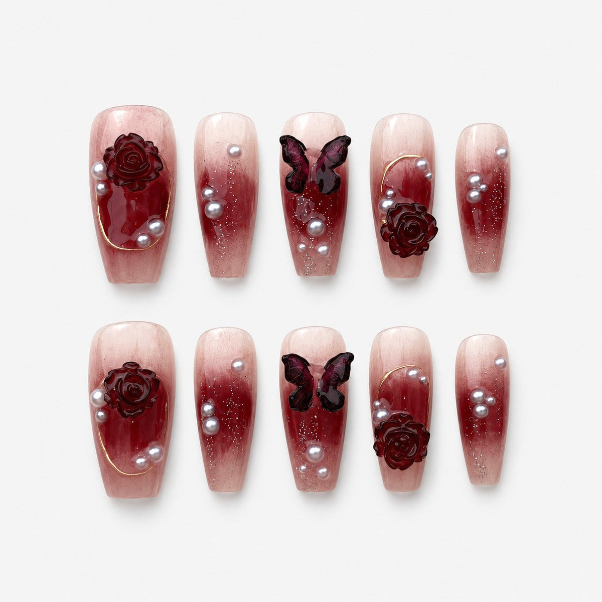 catalog: Coffin shaped press-on nails with a wine red to nude gradient, sculpted dark red roses, a carved butterfly, grey pearls and fine gold lines.
