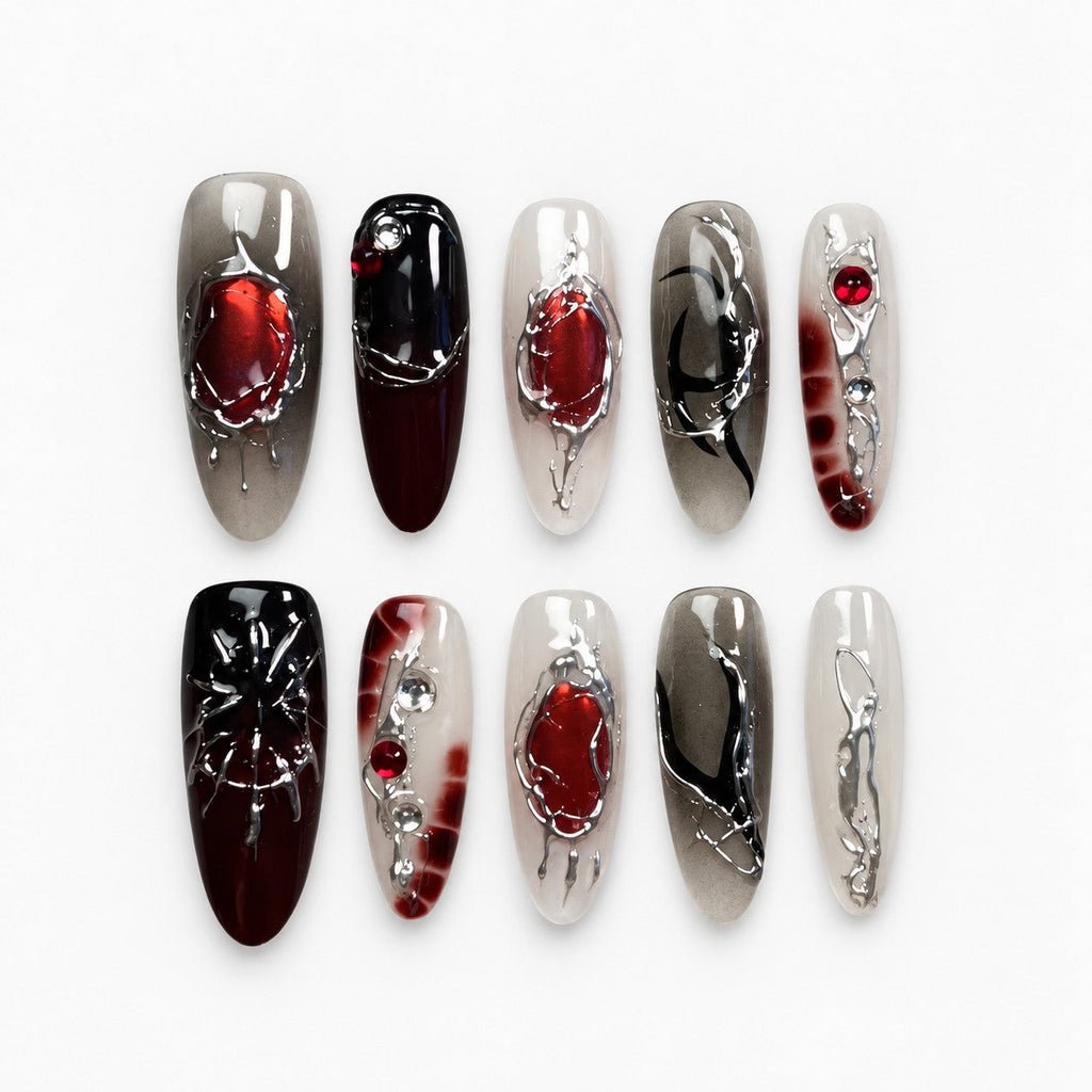 catalog: Long almond press-on nails in smoky grey and black with red stones, silver chrome veins and a sculpted spider.