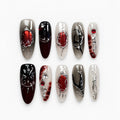 catalog: Long almond press-on nails in smoky grey and black with red stones, silver chrome veins and a sculpted spider.