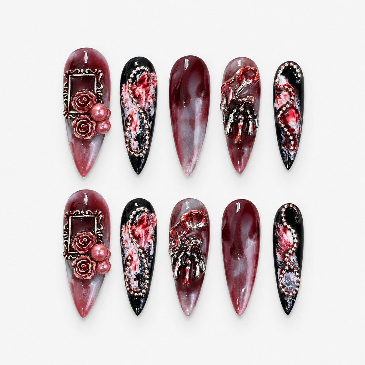 catalog: Long stiletto press-on nails in blood red marble with sculpted roses, pearls, rose gold frames, silver skeleton hands and glossy black tips.