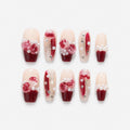 catalog: Medium coffin-shaped press-on nails with a dark red to nude gradient, sculpted pink and red roses, white pearls and small crystals.