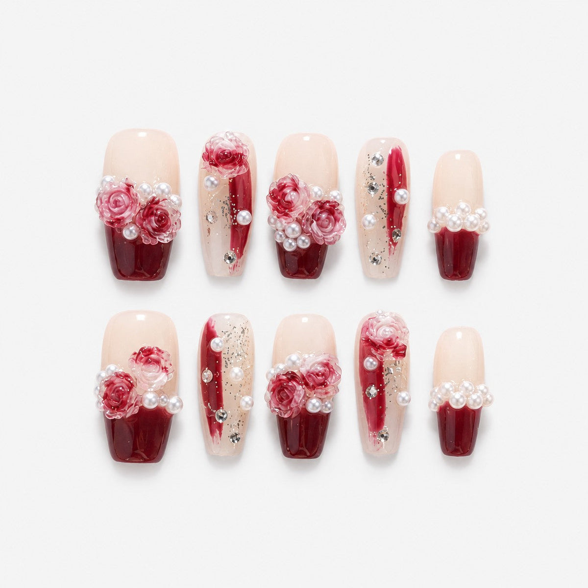 catalog: Medium coffin-shaped press-on nails with a dark red to nude gradient, sculpted pink and red roses, white pearls and small crystals.