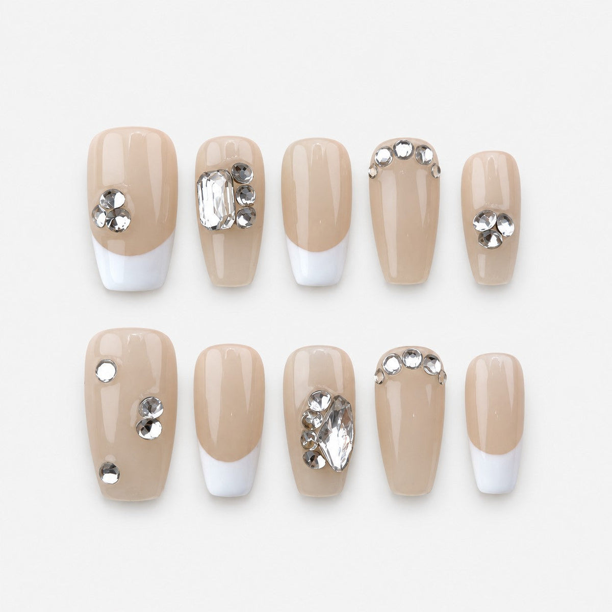 catalog: Medium square press-on nails in glossy nude with white French tips and clear rhinestone accents.