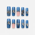 catalog: Long square press-on nails in speckled denim blue with sheer pink accents, silver rose and bow charms, pearls and small crystals.