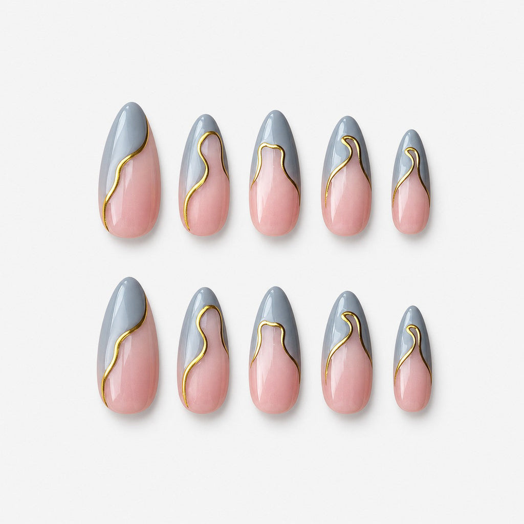 catalog: Medium almond press-on nails with a sheer pink base, grey wavy French tips and a thin gold line along each curve.