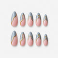 catalog: Medium almond press-on nails with a sheer pink base, grey wavy French tips and a thin gold line along each curve.