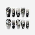 catalog: Coffin shaped press-on nails with black and grey gradient, silver glitter, crystal snowflake charms and mirrored star studs.