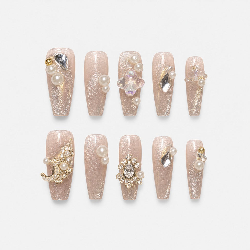 catalog: Long clear coffin nails with silvery glitter, raised cream pearls and clear faceted crystal stones.
