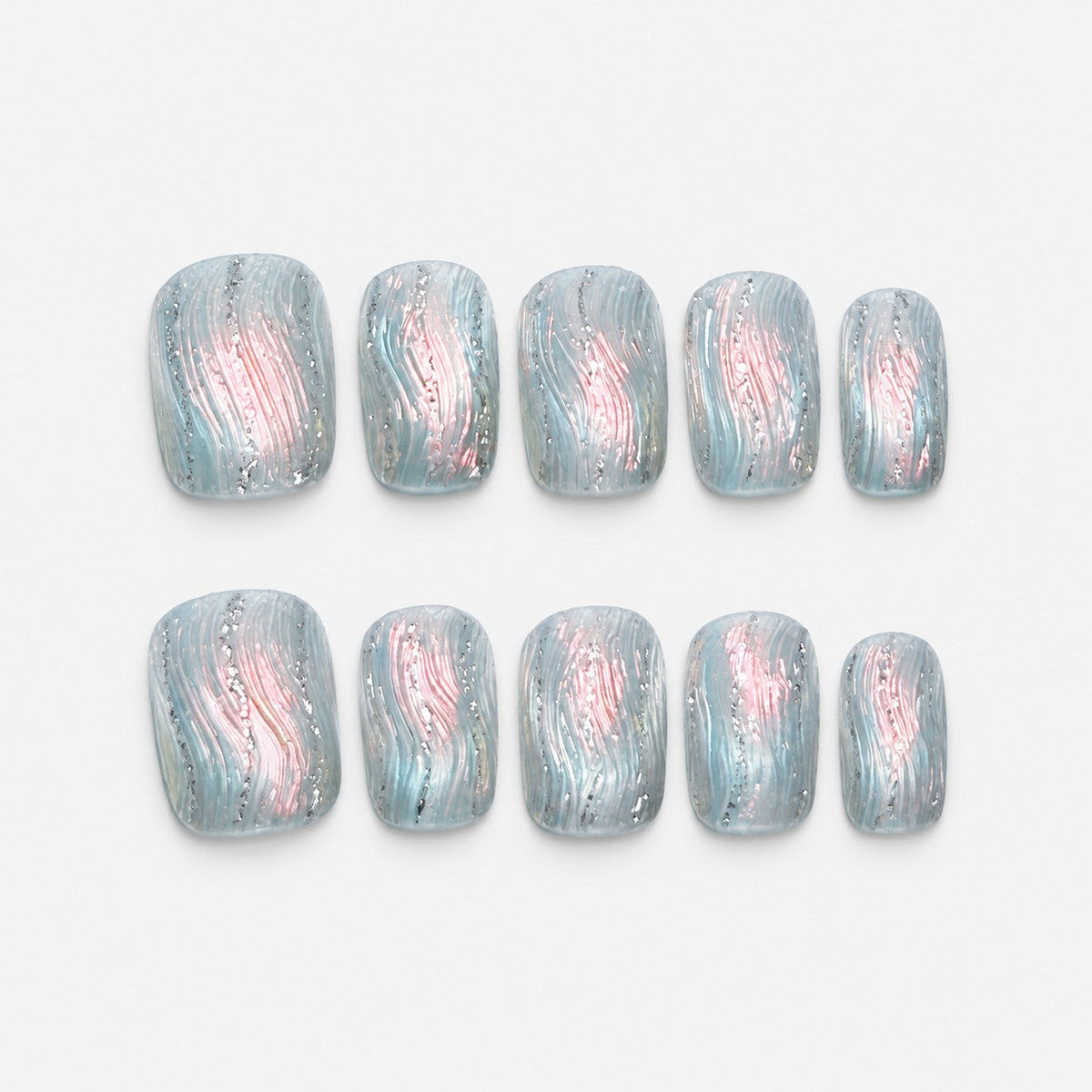 catalog: Short square press-on nails in frosted ice blue with textured ripples, a pearly pink shimmer through the centre and silver glitter lines.