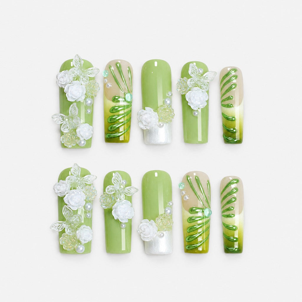 catalog: Long square press-on nails in soft green with painted emerald vines, sculpted white roses, butterflies and pearl beading.
