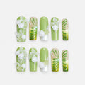 catalog: Long square press-on nails in soft green with painted emerald vines, sculpted white roses, butterflies and pearl beading.