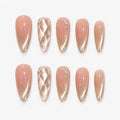 catalog: Long almond press-on nails in nude pink fading to mirror champagne gold, one with a quilted diamond texture, plus glitter and small crystals.