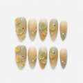 catalog: Medium almond nails in cream and pale sage ombre with sculpted yellow and mint roses, gold leaf accents and strands of ivory pearls.