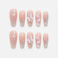 catalog: Long coffin press-on nails in sheer nude pink with silver shimmer, a sculpted white butterfly, sheer petal wings and small pearls.
