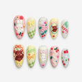 catalog: Medium almond press-on nails in pastel pink, yellow and mint with 3D bunny, bear, bow, cherry and cream swirl charms.