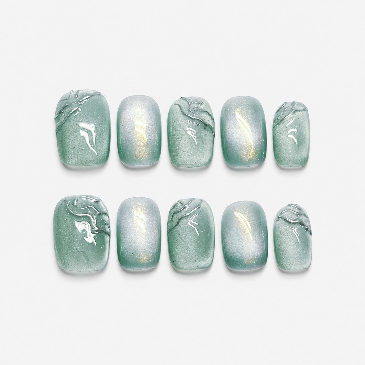 catalog: Short square press-on nails in sage green with a pearly cat-eye shimmer and raised clear brushstroke detail.