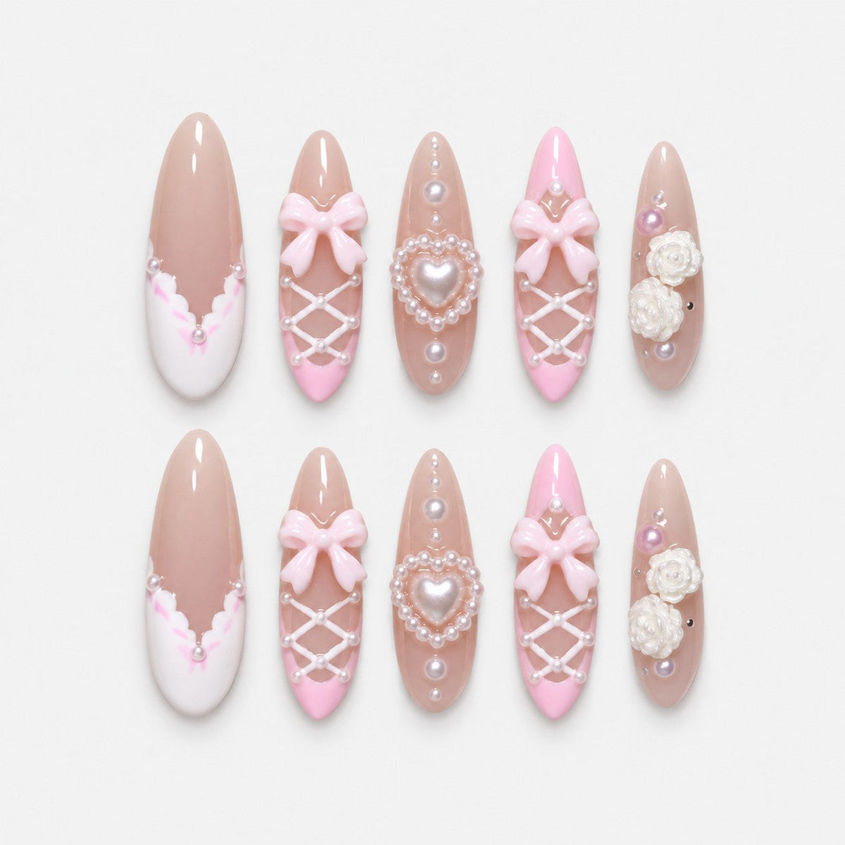 catalog: Long almond press-on nails in sheer nude with pink French tips, white corset lacing, pearls, sculpted pink bows and a pearl heart charm.