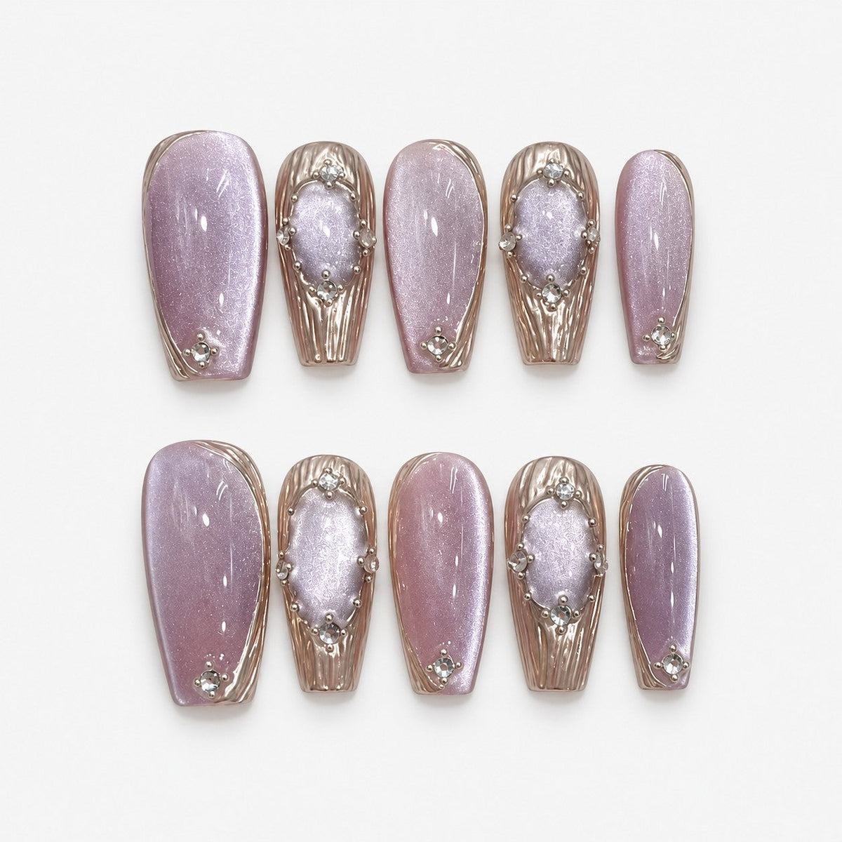 catalog: Medium almond press-on nails in shimmering lilac cat-eye with sculpted chrome petal accents and small crystal clusters.