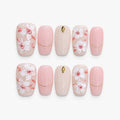 catalog: Medium square press-on set in milky pink with raised white magnolia flowers, coral brushstrokes and thin gold lines.