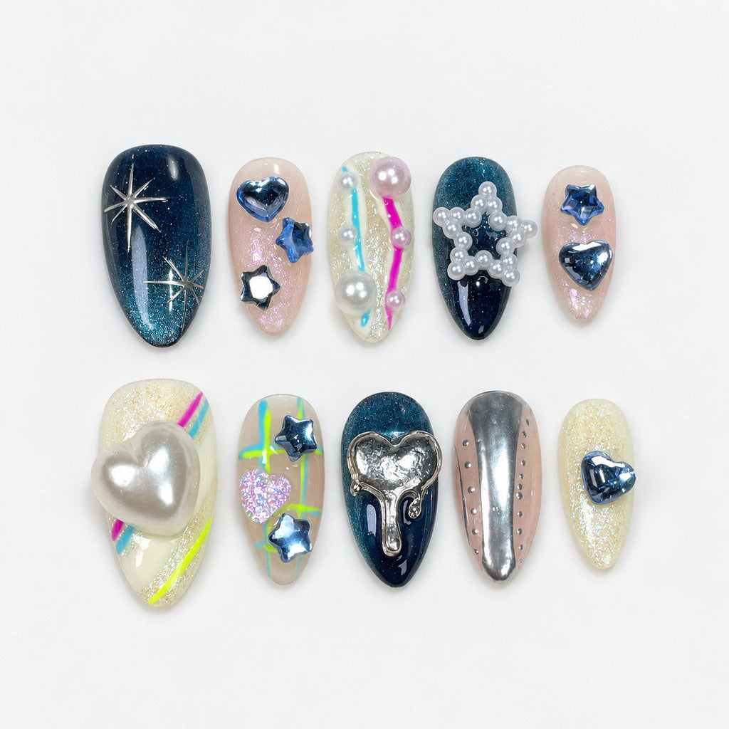 catalog: Medium almond press-on set mixing deep teal cat-eye nails, silver starbursts, chrome hearts, pearl star charms and neon line art.