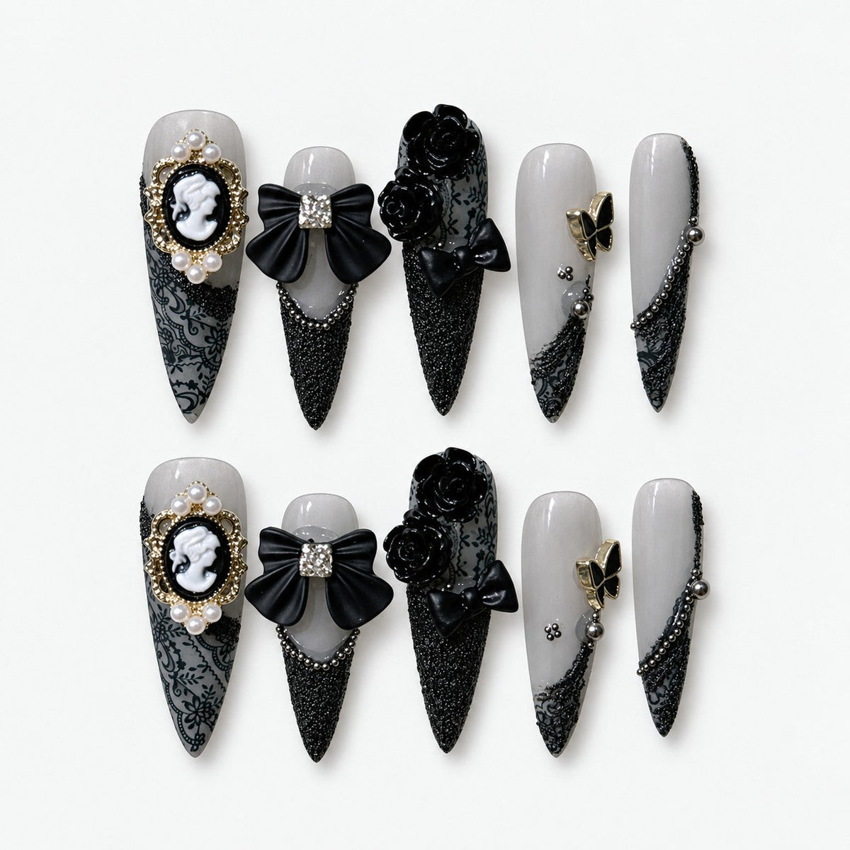 catalog: Long stiletto nails in frosted grey with black lace print, a pearl framed cameo, black bows and sculpted black roses.