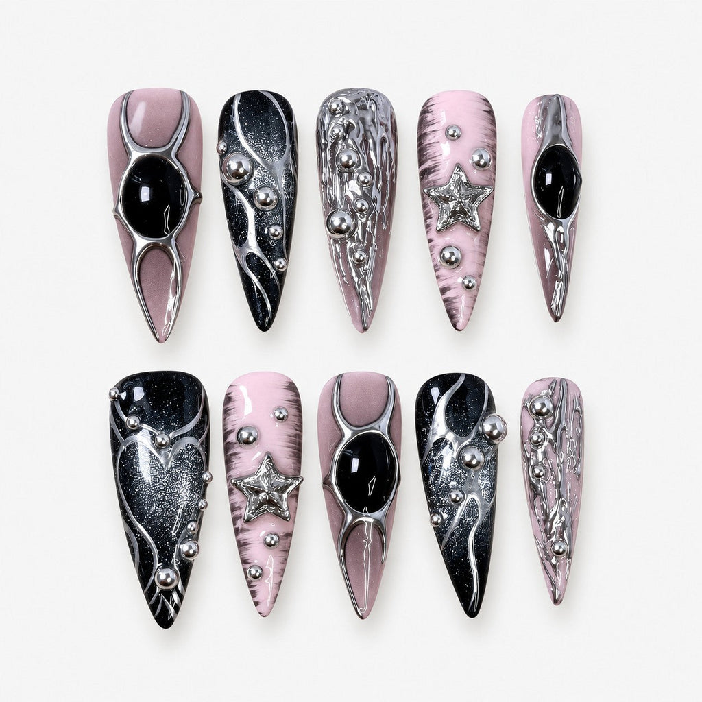 catalog: Long stiletto press-on nails in mauve pink and black with liquid chrome silver detailing, black cabochon stones, silver beads and a sculpted star.
