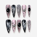 catalog: Long stiletto press-on nails in mauve pink and black with liquid chrome silver detailing, black cabochon stones, silver beads and a sculpted star.