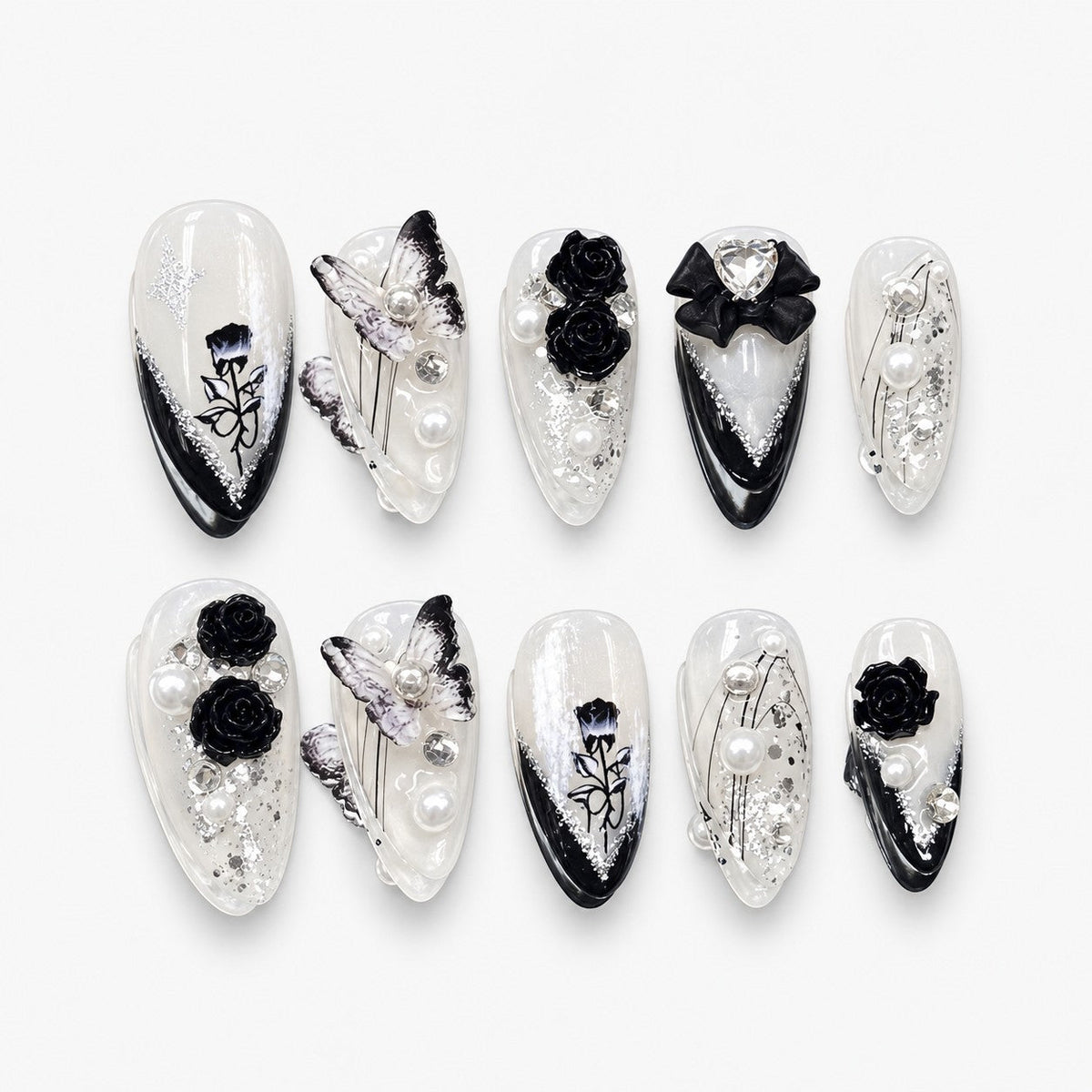 catalog: Almond medium press-on nails in pearl white with glossy black tips, sculpted black roses, a black bow, pearls and rhinestones.