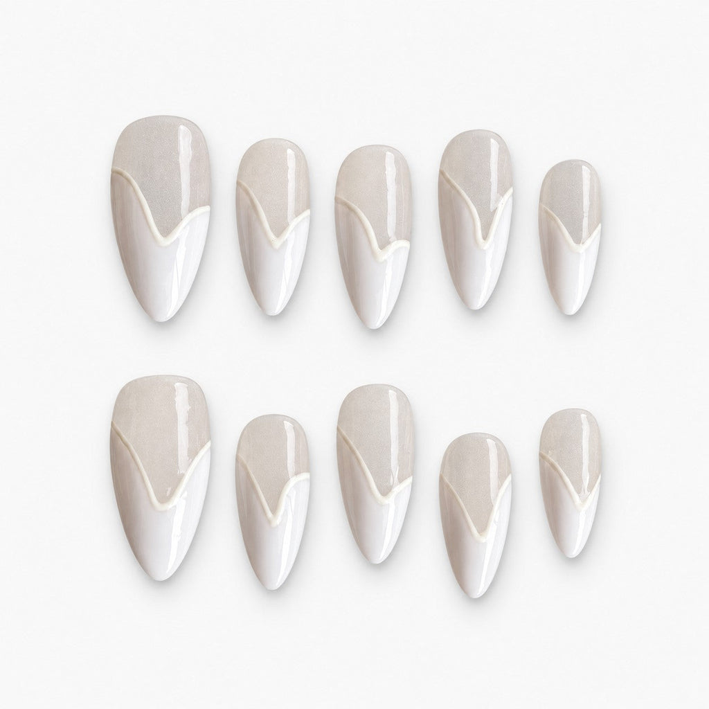 catalog: Medium almond press-on nails in pearly off-white with a raised white chevron French tip and a high-gloss finish.