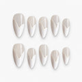 catalog: Medium almond press-on nails in pearly off-white with a raised white chevron French tip and a high-gloss finish.