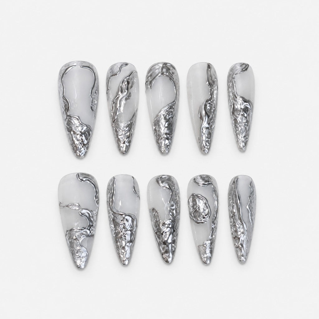 catalog: Long almond press-on nails in milky white with raised liquid silver chrome sculpted along the edges and tips.