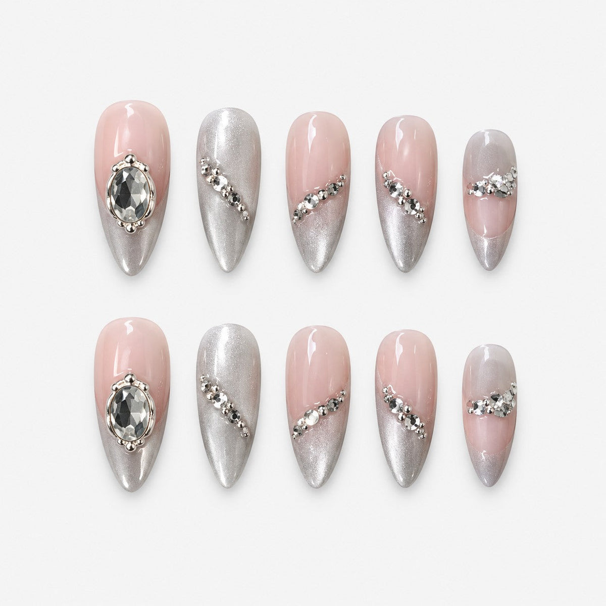 catalog: Medium almond press-on nails in nude with pearly silver cat-eye shimmer, crystal accents along the edges and two large faceted stones.