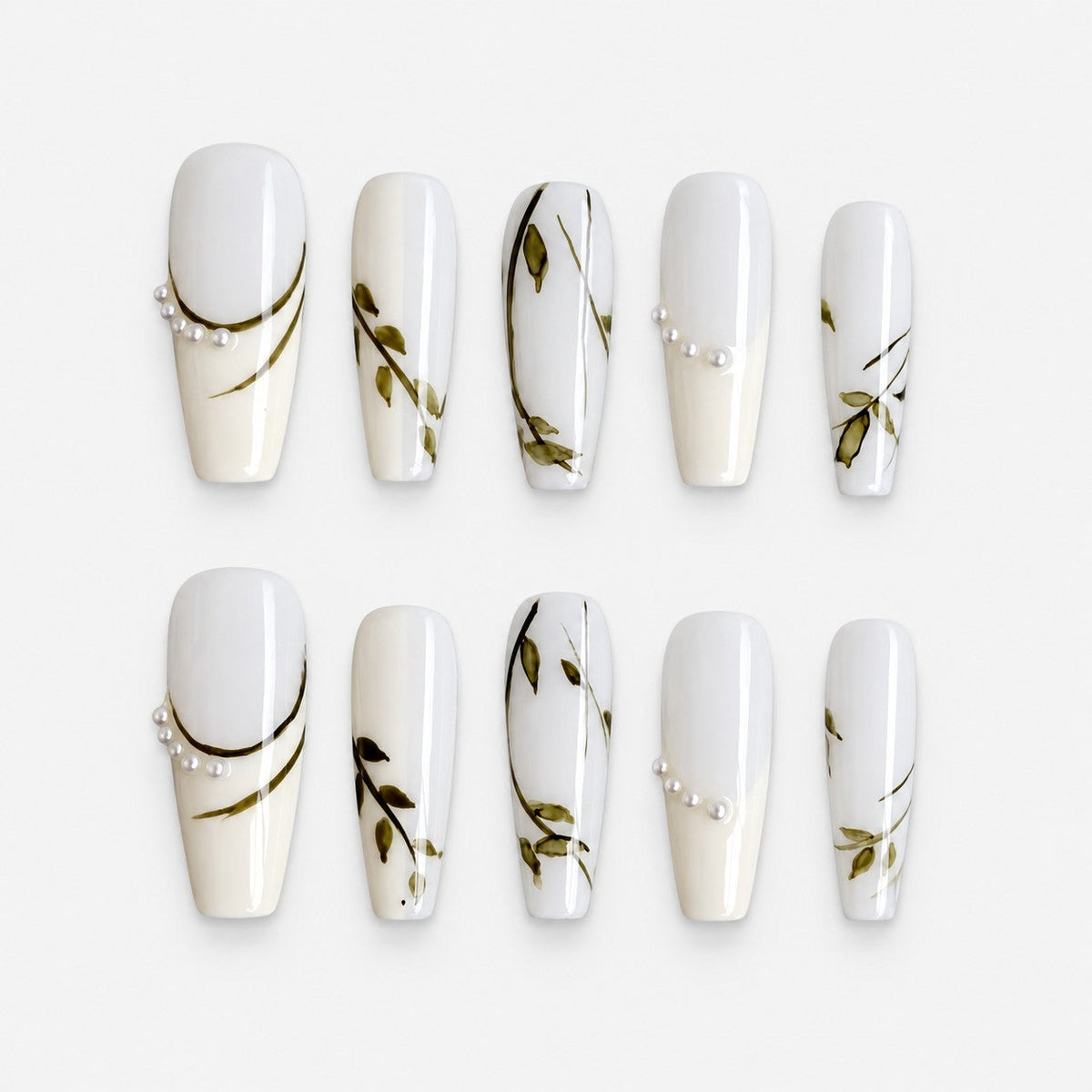 catalog: Long coffin press-on nails in milky white with painted olive branches and small white pearls near the cuticle.