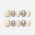 catalog: Short square nails in creamy off white with two rose gold glitter accent nails holding iridescent aurora shards.