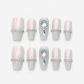 catalog: Medium coffin nails in pink opal chrome with a rhinestone band, frosted silver glitter tips and teardrop crystal accents.